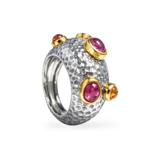 Handmade silver dome ring with pink sapphire and citrine gemstones, accented by gold in an artisan-crafted design.