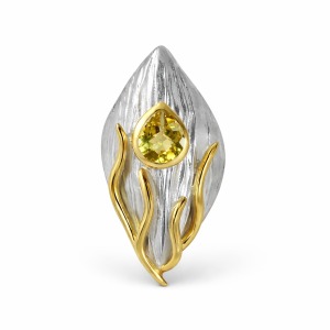 Handmade modern silver ring with gold accents and a pear-cut lemon quartz gemstone, showcasing a sculptural and bold design.